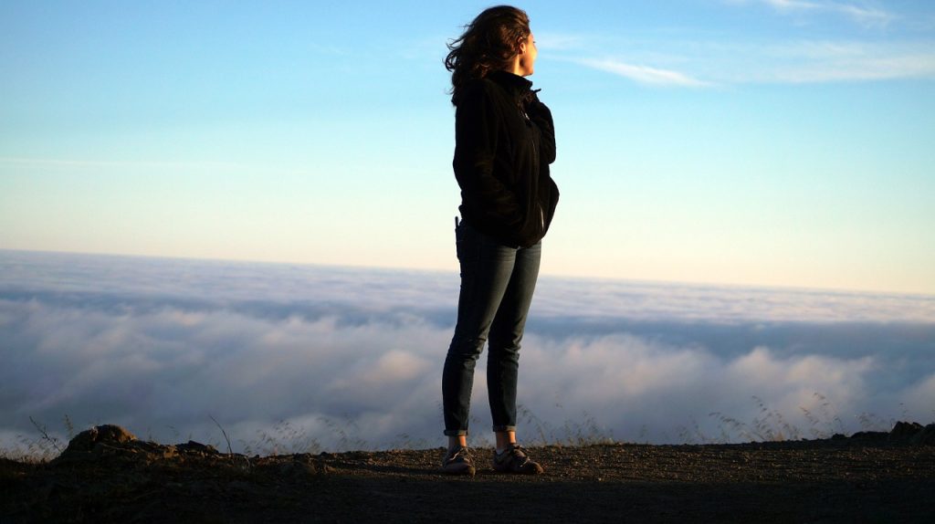 Woman looking out over mountain top